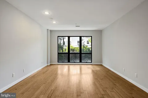 a view of room with wooden floor