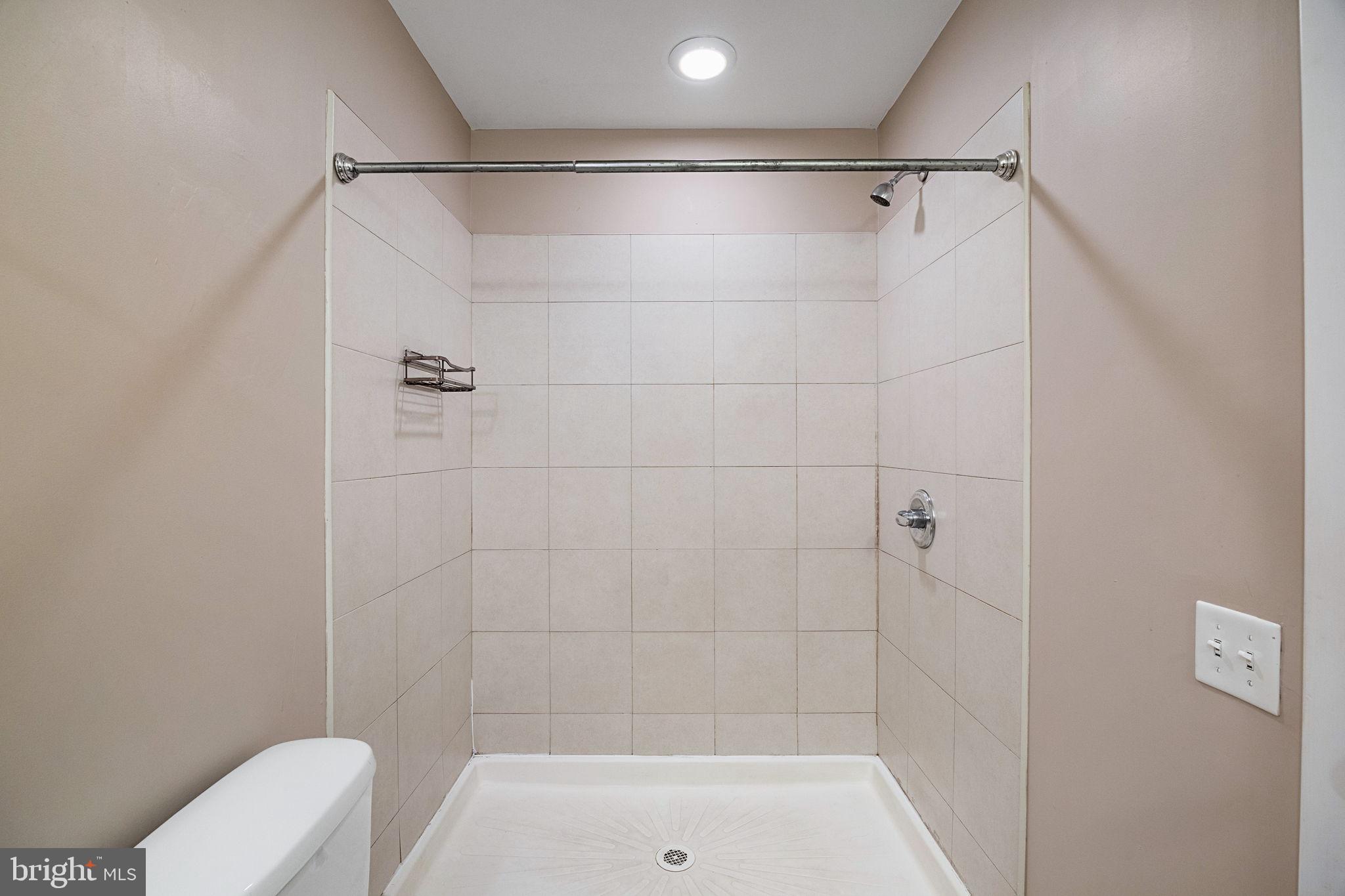 934 North 3rd Street, Unit 205 Philadelphia, PA 19123 - Photo 29 of 39 a bathroom with a shower and toilet