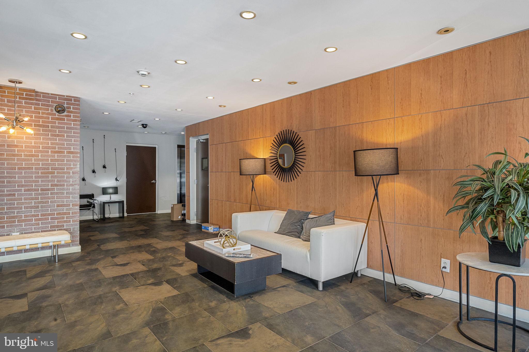 934 North 3rd Street, Unit 205 Philadelphia, PA 19123 - Photo 35 of 39 a living room with furniture and a potted plant