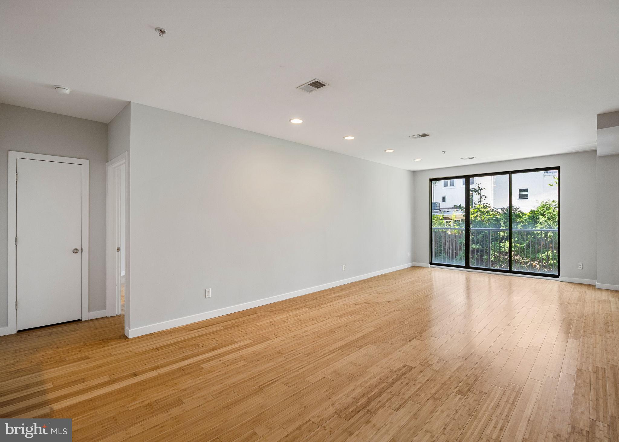 934 North 3rd Street, Unit 205 Philadelphia, PA 19123 - Photo 4 of 39 a view of an empty room with wooden floor and a window