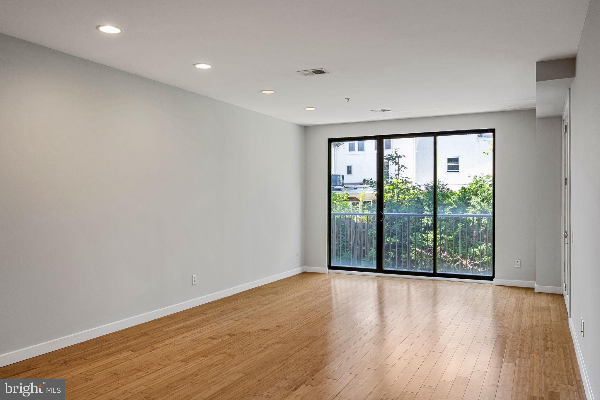 934 North 3rd Street, Unit 205 Philadelphia, PA 19123 - Photo 5 of 39 a view of an empty room with wooden floor and a window