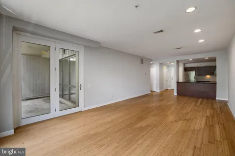 a view of empty room with wooden floor