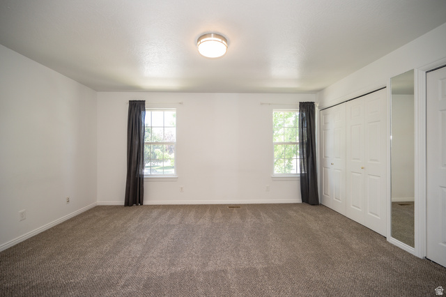 1799 West 1110th Street North Provo, UT 84604 - Photo 13 of 24 Carpeted room with white walls, dual windows, and ceiling-mounted lighting
