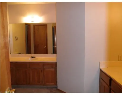 a view of a small space with a window and a chandelier fan