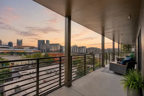 a view of a city view from a balcony with a bench