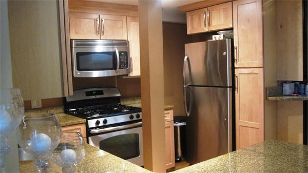 53 Corey Street, Unit B Everett, MA 02149 - Photo 1 of 30 a kitchen with a refrigerator and a stove