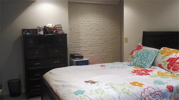 53 Corey Street, Unit B Everett, MA 02149 - Photo 24 of 30 a bedroom with a bed and a dresser