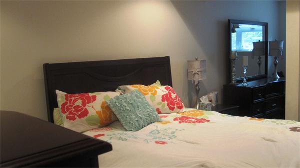 53 Corey Street, Unit B Everett, MA 02149 - Photo 25 of 30 a bedroom with a bed and a painting on the wall