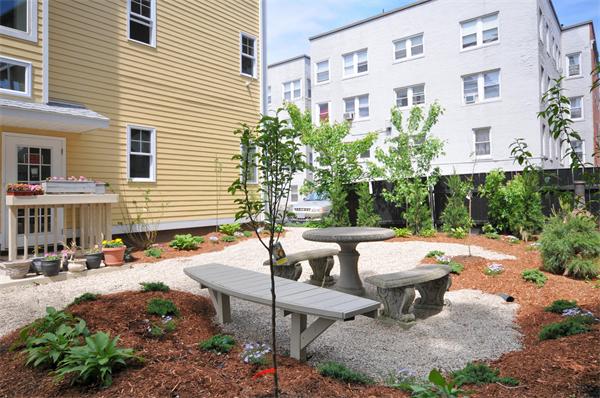 53 Corey Street, Unit B Everett, MA 02149 - Photo 6 of 30 a view of a patio with table and chairs and potted plants