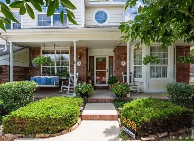 front view of a house with potted plants and a potted plant
