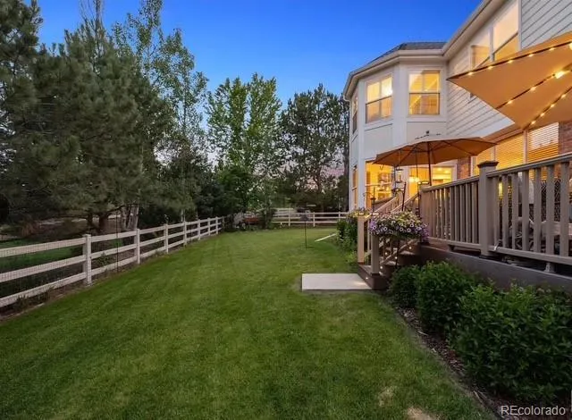 a view of a bench in the garden near a lake