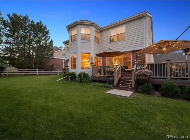 a front view of a house with a yard table and chairs
