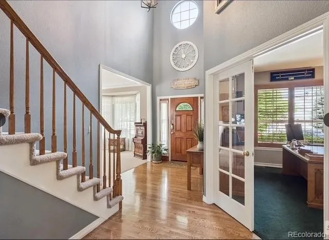 a view of an entryway with wooden floor and a front door