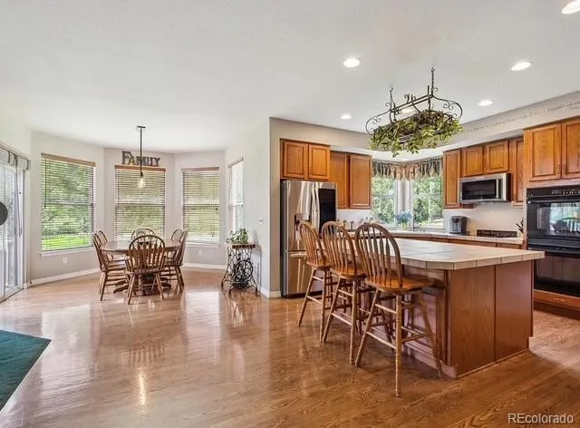 a view of a dining room with furniture window and wooden floor