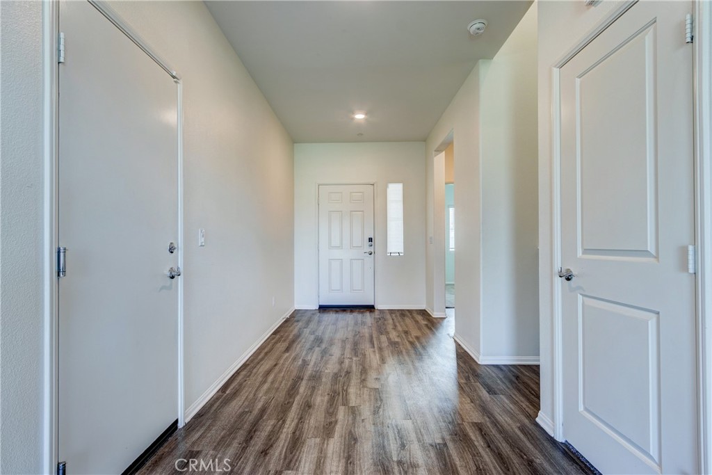28295 Memory Lane Winchester, CA 92596 - Photo 16 of 68 a view of a hallway with wooden floor and a bathroom