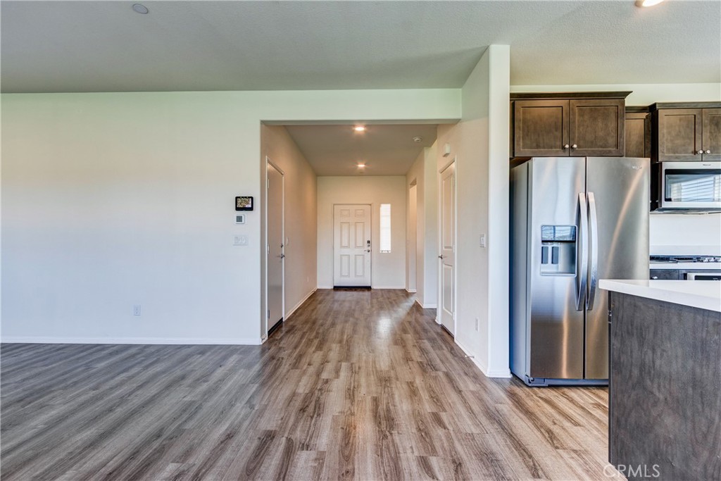 28295 Memory Lane Winchester, CA 92596 - Photo 20 of 68 a view of a refrigerator in kitchen and wooden floor