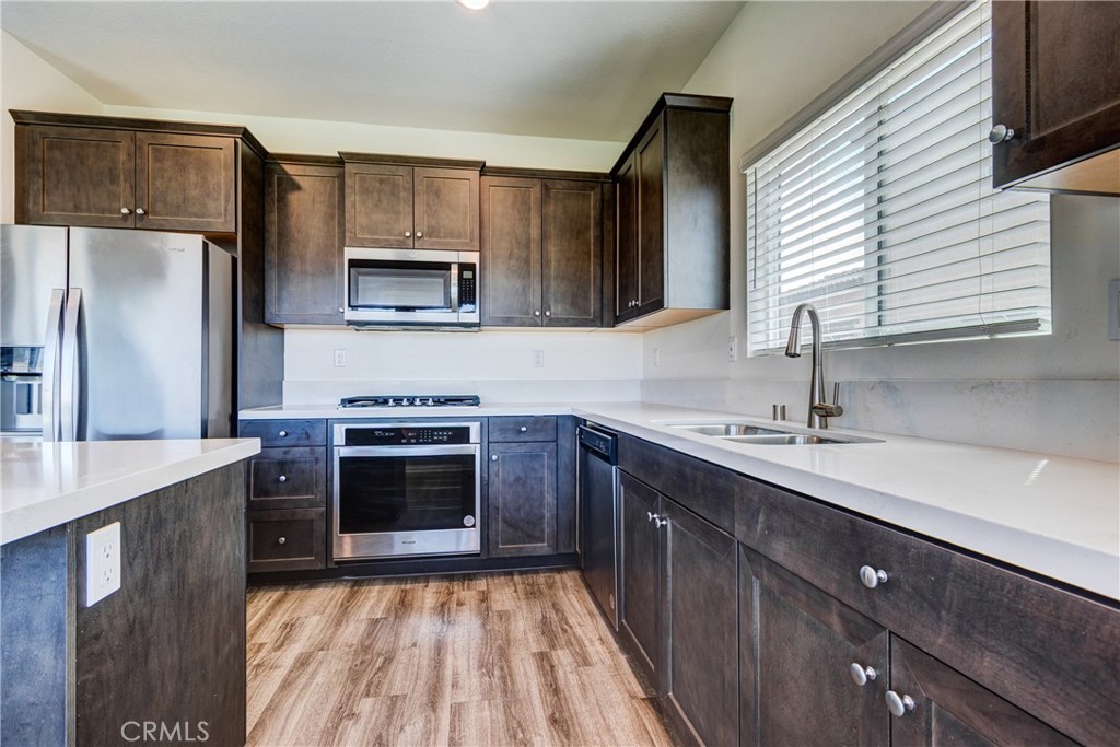 28295 Memory Lane Winchester, CA 92596 - Photo 21 of 68 a kitchen with a sink stove and refrigerator