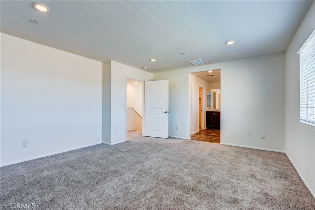 28295 Memory Lane Winchester, CA 92596 - Photo 29 of 68 a view of an empty room with wooden floor and windows