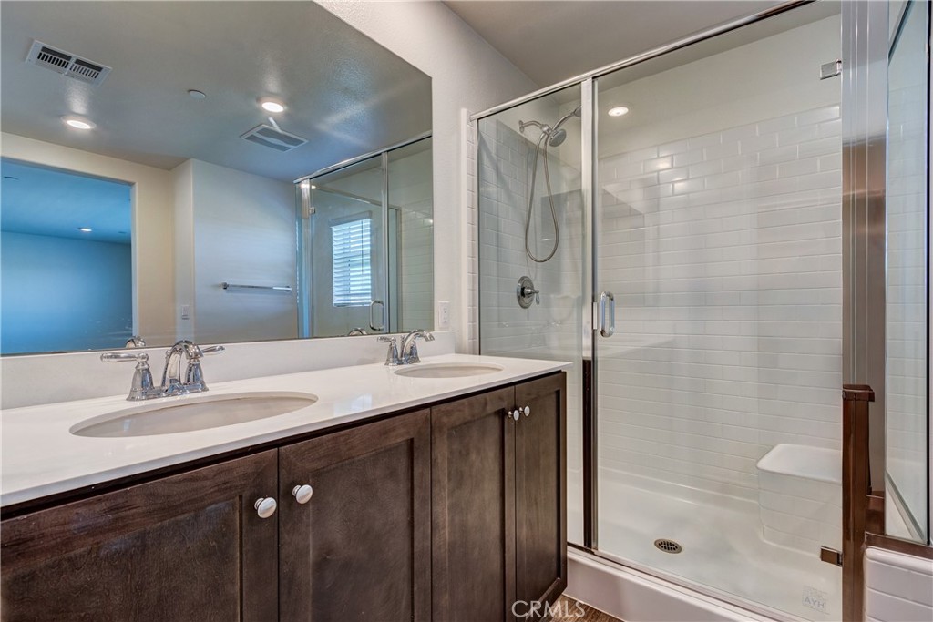 28295 Memory Lane Winchester, CA 92596 - Photo 32 of 68 a bathroom with a double vanity sink mirror and shower