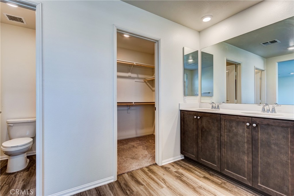 28295 Memory Lane Winchester, CA 92596 - Photo 33 of 68 a spacious bathroom with a double vanity sink a toilet and a mirror