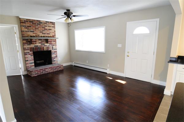 96 Adams Road Grafton, MA 01536 - Photo 12 of 24 an empty room with wooden floor fireplace and windows