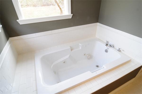 96 Adams Road Grafton, MA 01536 - Photo 18 of 24 a white bath tub sitting in a bathroom