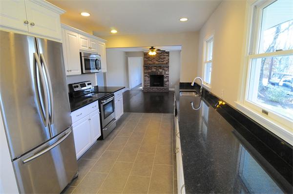 96 Adams Road Grafton, MA 01536 - Photo 3 of 24 a large kitchen with a refrigerator a stove top oven a sink and dishwasher