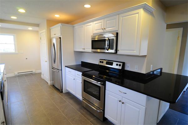 96 Adams Road Grafton, MA 01536 - Photo 4 of 24 a kitchen with stainless steel appliances a stove microwave and a refrigerator