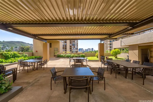a view of a patio with table and chairs potted plants with wooden floor and seating space