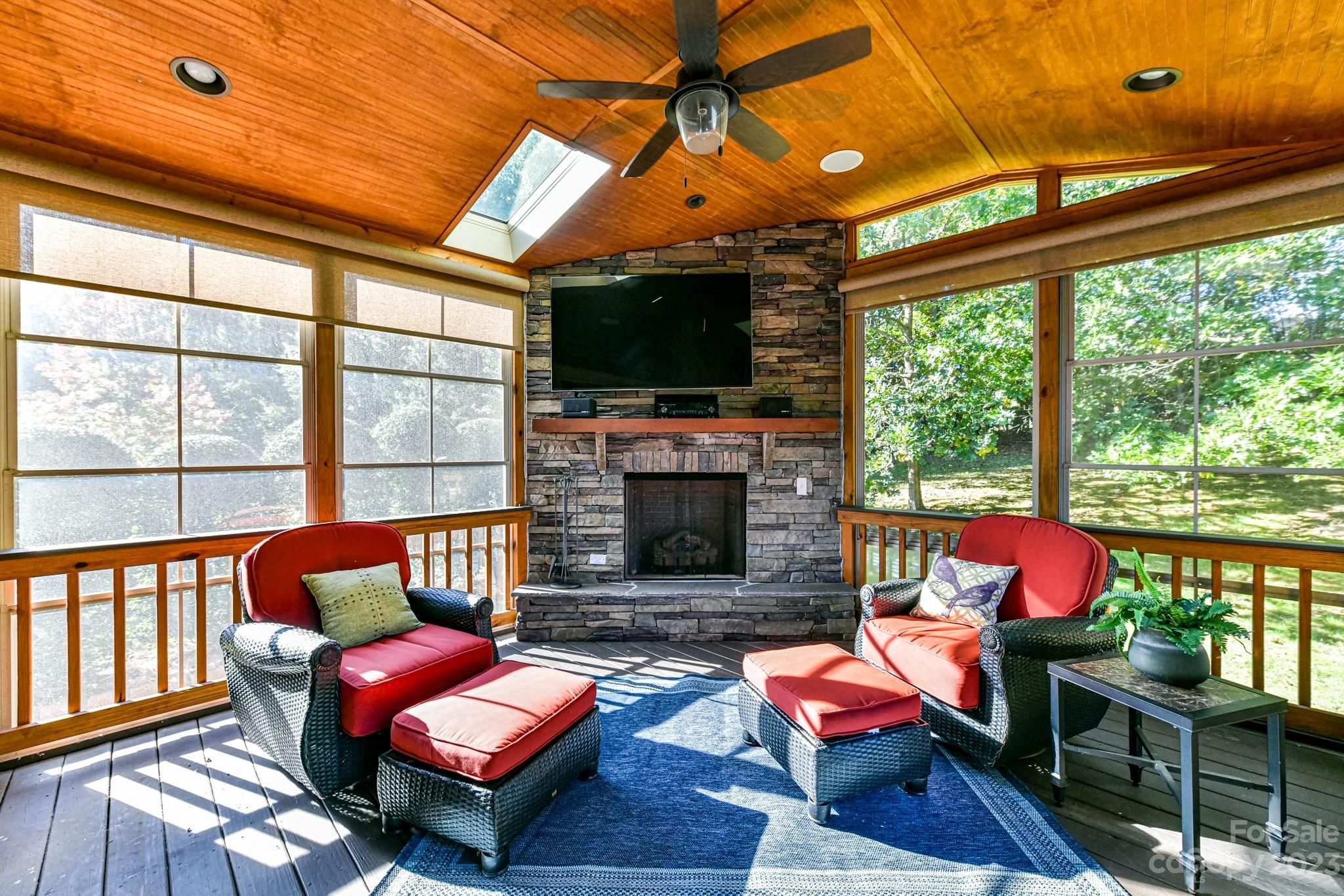 4030 Fawn Hill Road Matthews, NC 28105 - Photo 11 of 48 a living room with furniture a fireplace and a floor to ceiling window