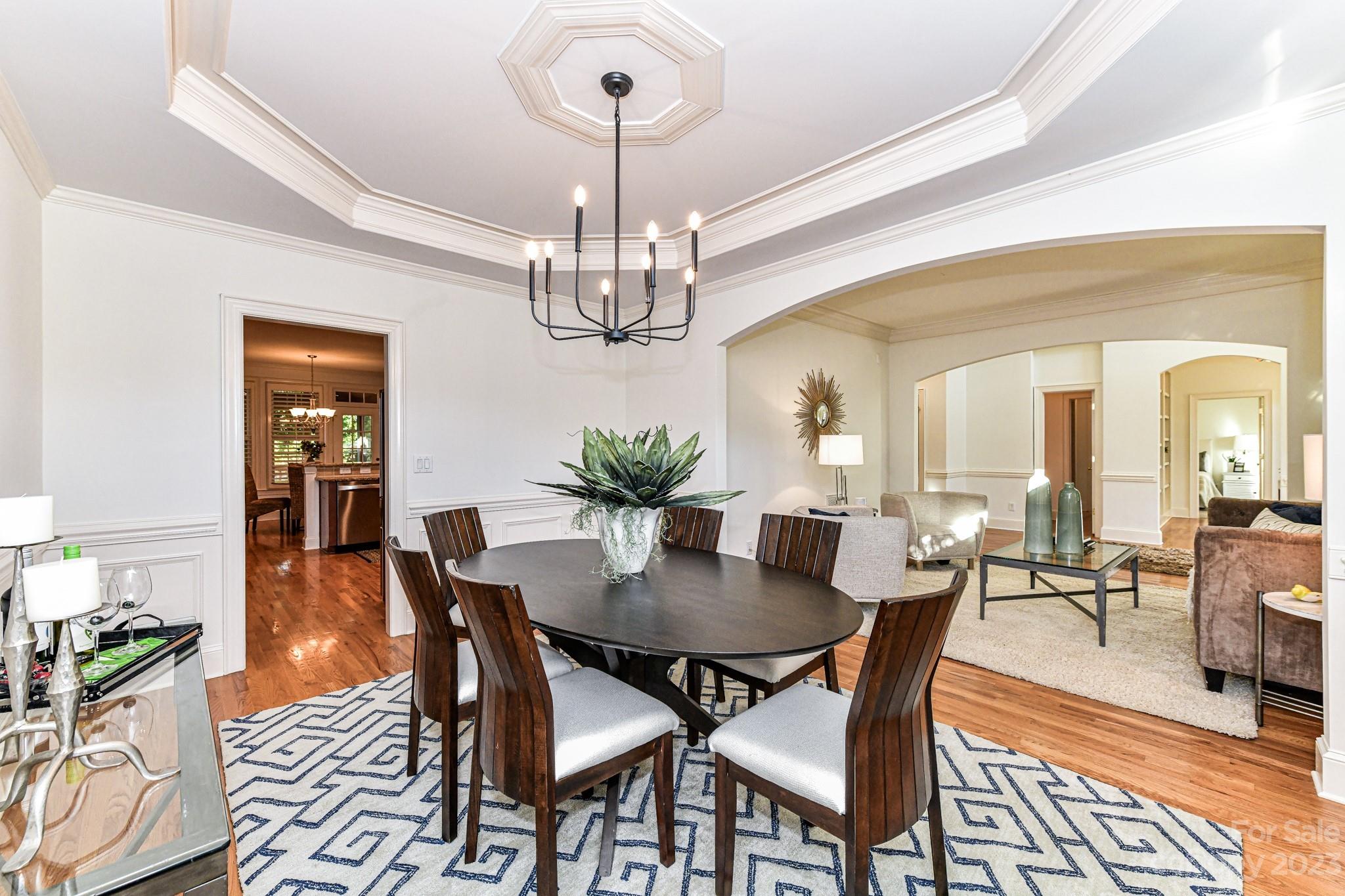 4030 Fawn Hill Road Matthews, NC 28105 - Photo 14 of 48 a view of a dining room with furniture wooden floor and chandelier