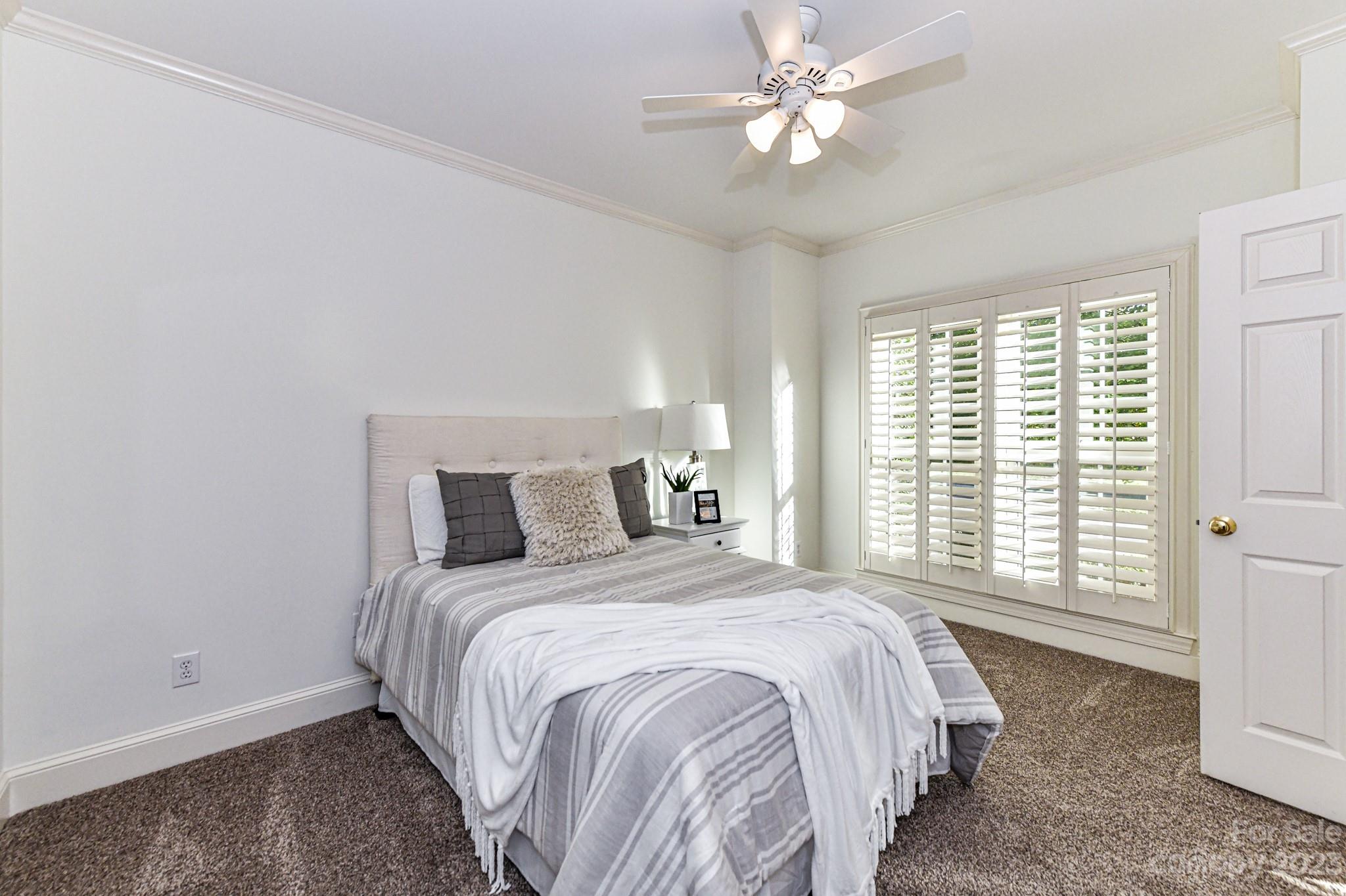 4030 Fawn Hill Road Matthews, NC 28105 - Photo 16 of 48 a bedroom with a bed and a ceiling fan