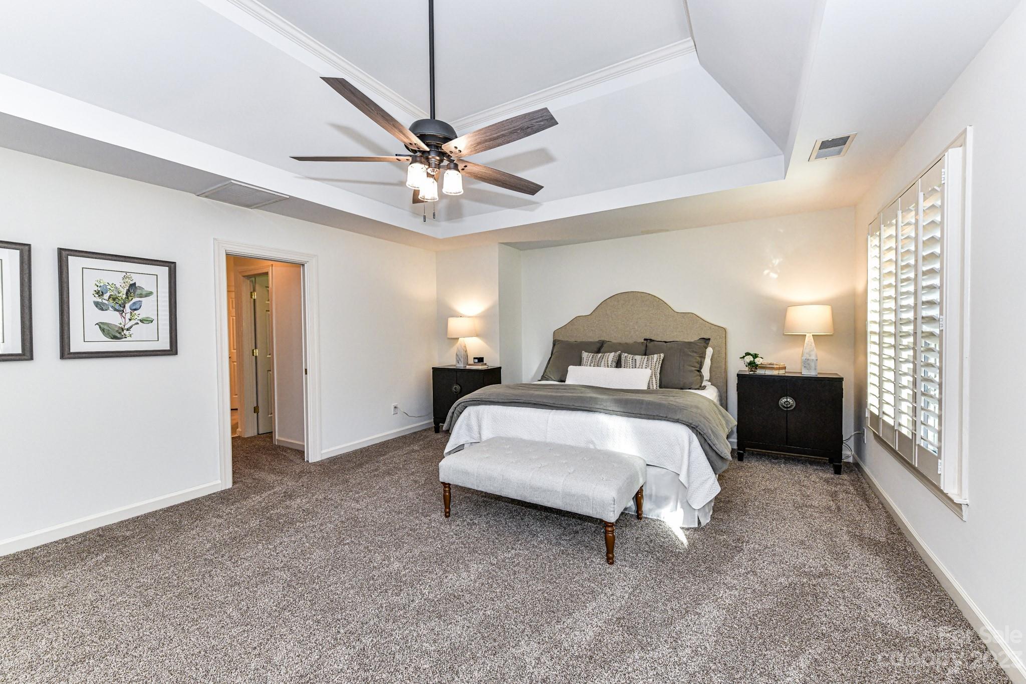 4030 Fawn Hill Road Matthews, NC 28105 - Photo 21 of 48 a bedroom with a bed and a chandelier