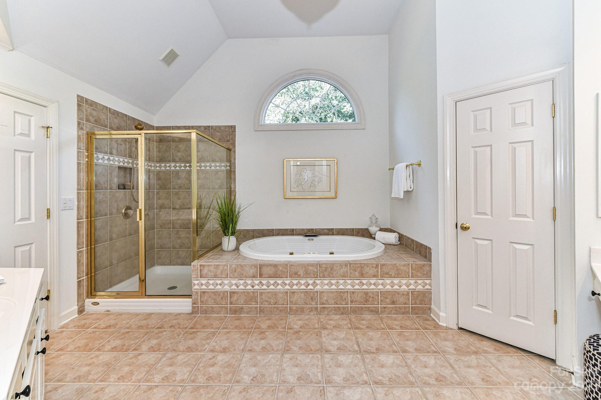 4030 Fawn Hill Road Matthews, NC 28105 - Photo 23 of 48 a bathroom with a tub shower and window
