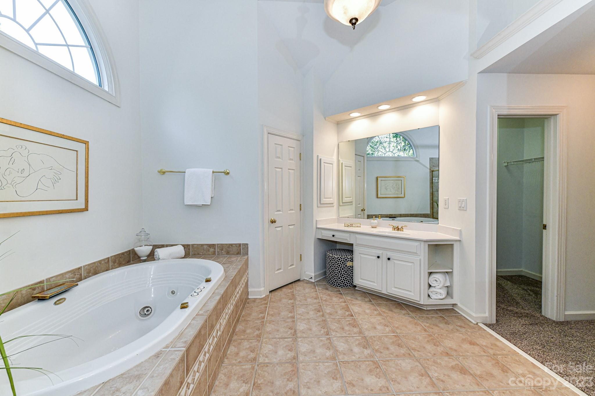 4030 Fawn Hill Road Matthews, NC 28105 - Photo 25 of 48 a spacious bathroom with a granite countertop tub sink shower and mirror