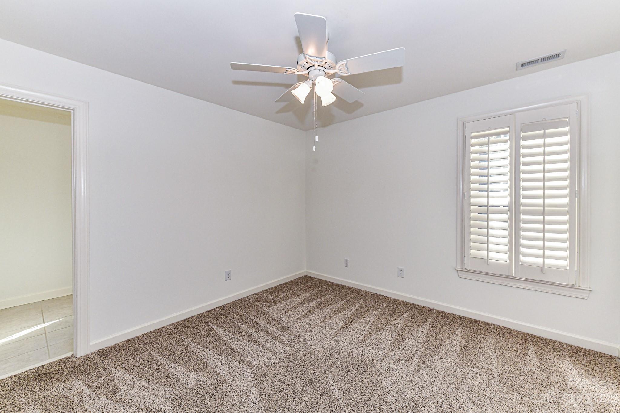 4030 Fawn Hill Road Matthews, NC 28105 - Photo 28 of 48 an empty room with a window and a fan