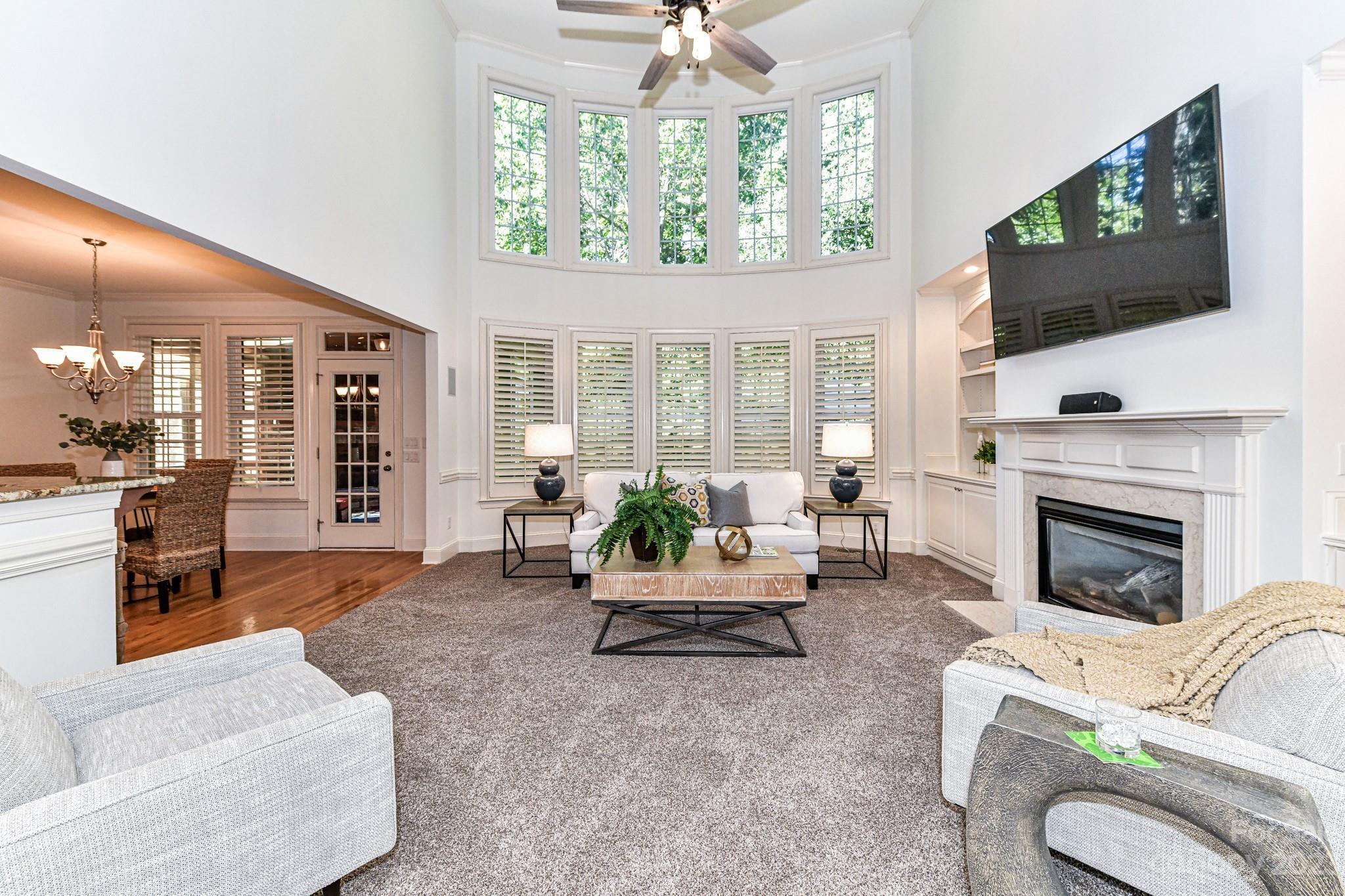 4030 Fawn Hill Road Matthews, NC 28105 - Photo 3 of 48 a living room with furniture a flat screen tv and a fireplace