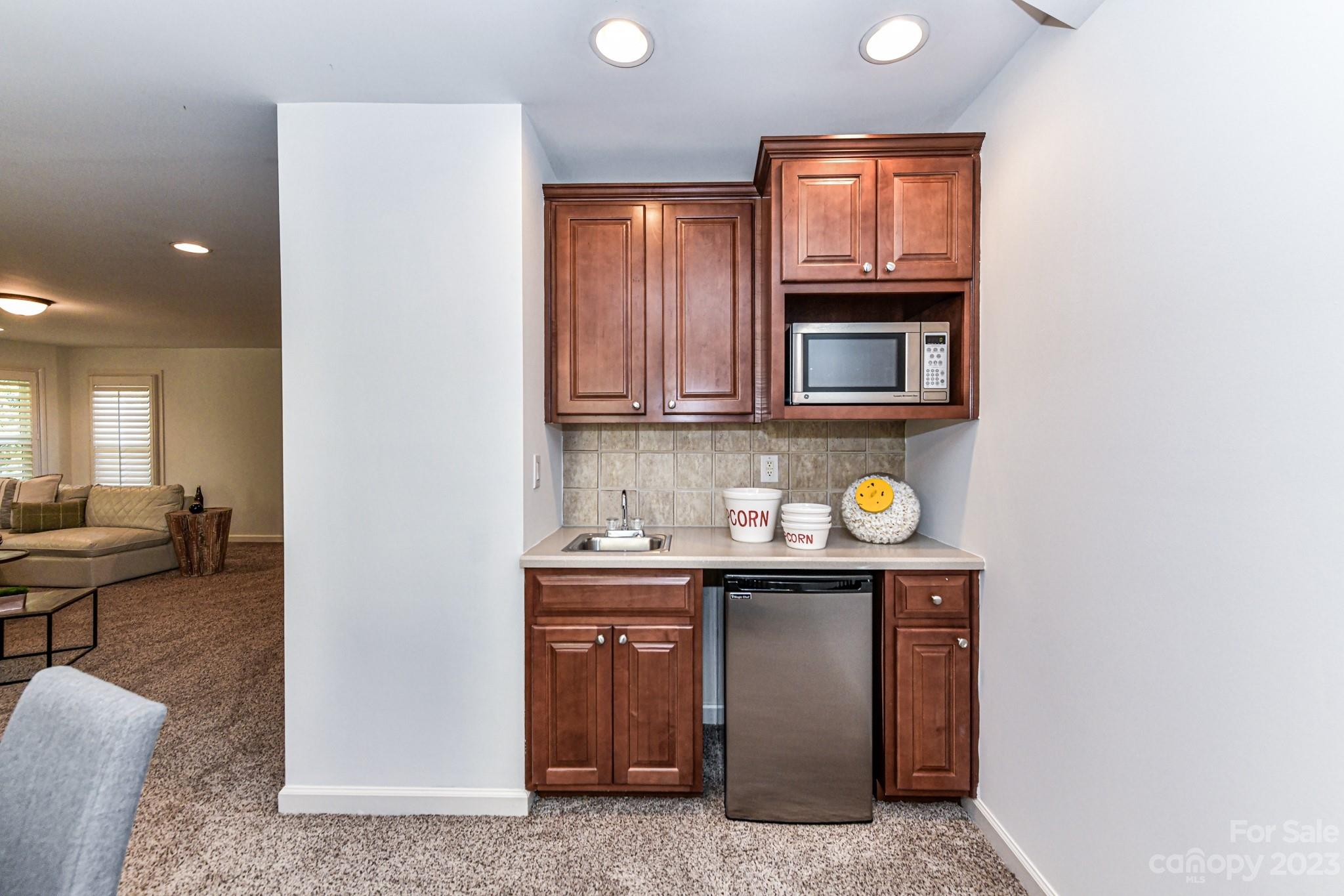 4030 Fawn Hill Road Matthews, NC 28105 - Photo 34 of 48 a kitchen with granite countertop a sink a stove and wooden cabinets