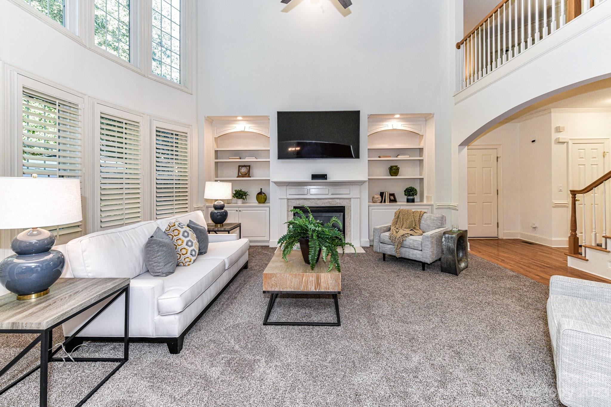 4030 Fawn Hill Road Matthews, NC 28105 - Photo 4 of 48 a living room with furniture a flat screen tv and a fireplace