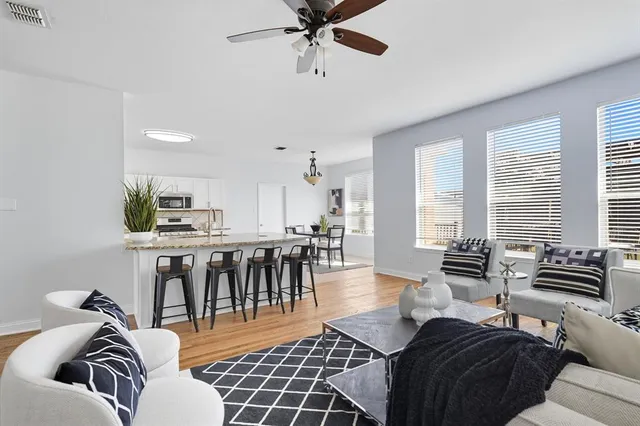 a living room with furniture and a potted plant