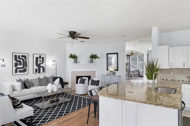 a kitchen with stainless steel appliances granite countertop a sink a stove and cabinets