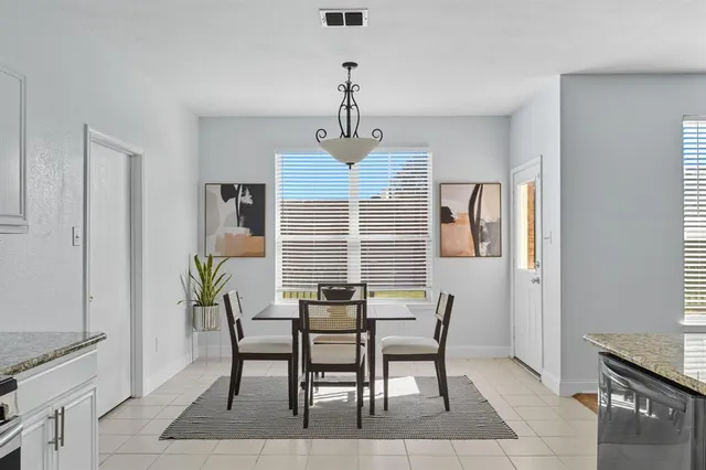 a kitchen with granite countertop white cabinets and stainless steel appliances