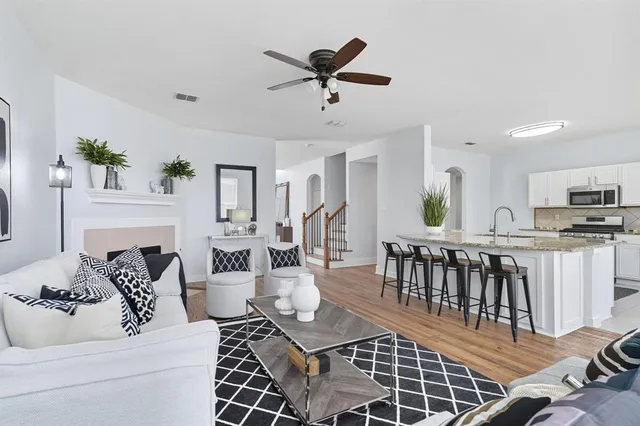 a living room with furniture a dining table and a fireplace