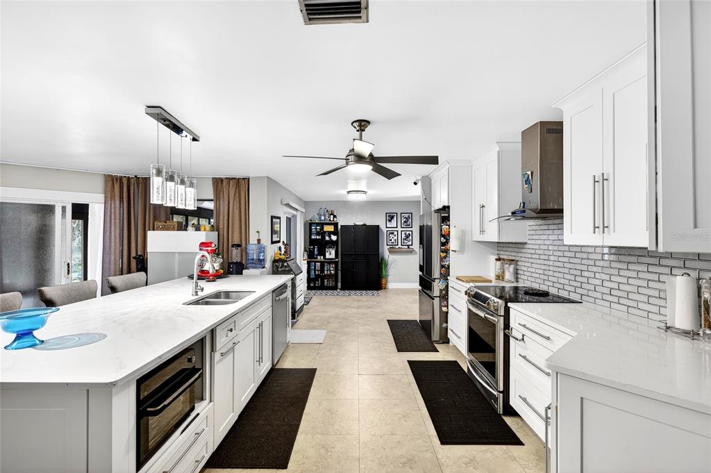 11795 Southwest Highway 484 Dunnellon, FL 34432 - Photo 12 of 51 a large kitchen with stainless steel appliances kitchen island granite countertop a sink and cabinets