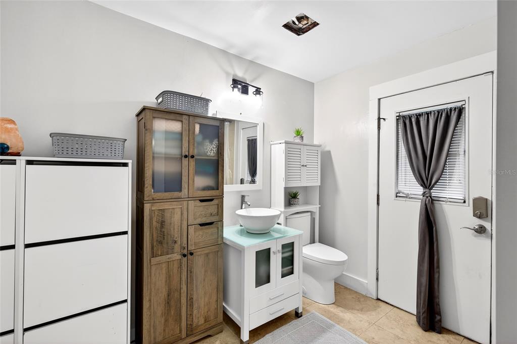 11795 Southwest Highway 484 Dunnellon, FL 34432 - Photo 34 of 51 a bathroom with a refrigerator sink vanity mirror and toilet