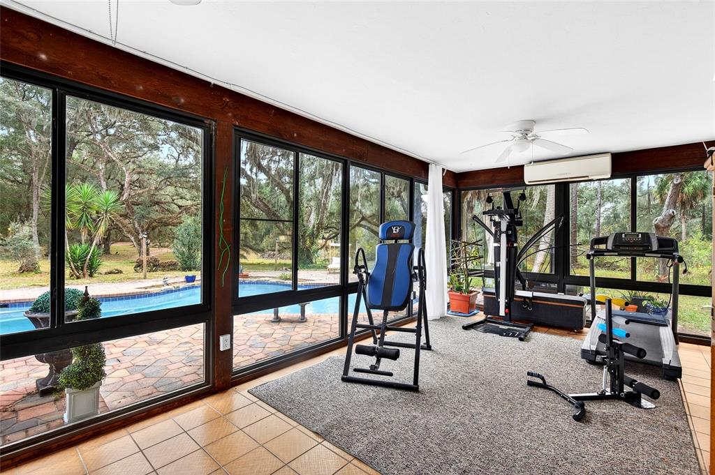 11795 Southwest Highway 484 Dunnellon, FL 34432 - Photo 37 of 51 a view of a room with gym equipment and a large window