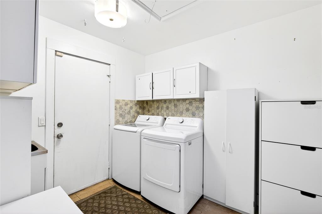 11795 Southwest Highway 484 Dunnellon, FL 34432 - Photo 4 of 51 a utility room with cabinets washer and dryer