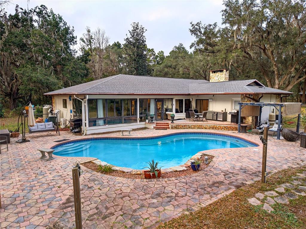 11795 Southwest Highway 484 Dunnellon, FL 34432 - Photo 43 of 51 a view of a swimming pool with chairs and tables