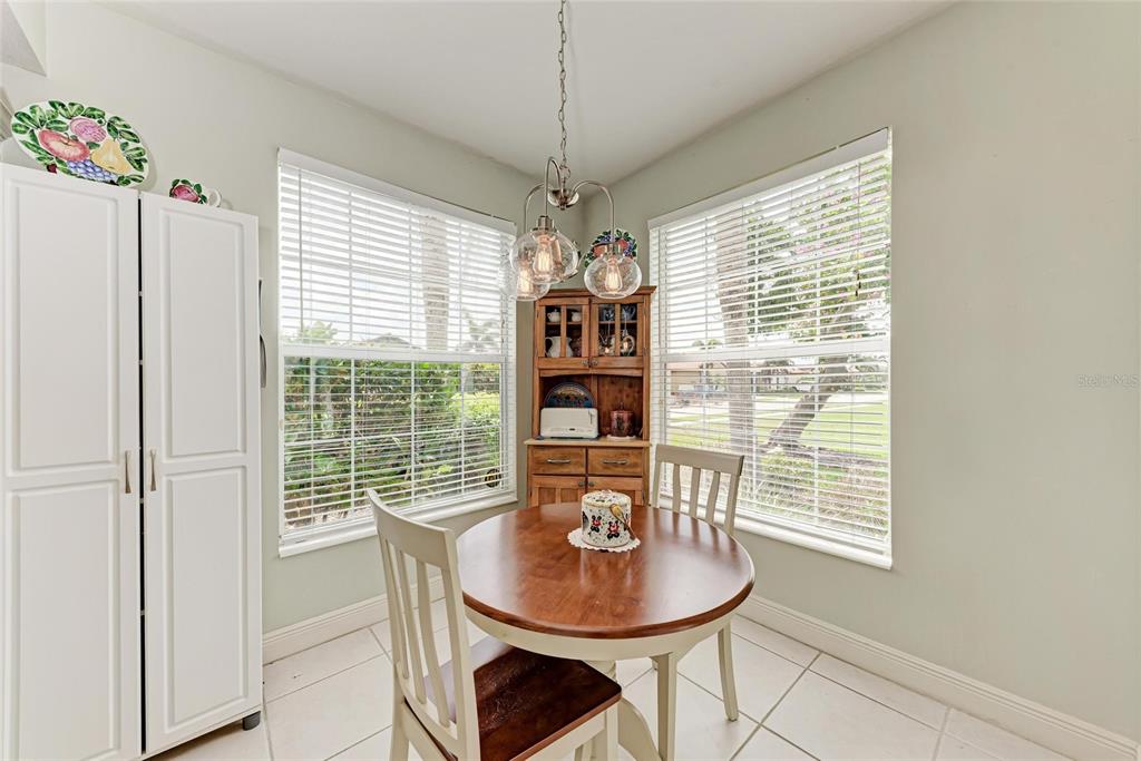 23261 Banbury Way, Unit 501 Venice, FL 34293 - Photo 11 of 75 a dining room with furniture and window