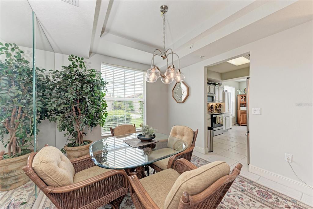 23261 Banbury Way, Unit 501 Venice, FL 34293 - Photo 14 of 75 a living room with furniture a window and a chandelier